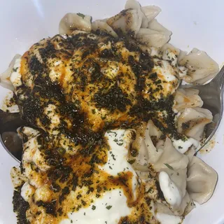 Mant, Small beef dumplings with garlic yogurt sauce and spices.