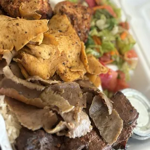 Four(Quad) Kebabs served with salad and rice.