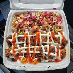 Adana Kebap over rice with garlic and hot sauce