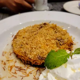 Kunefe- roasted vermicelli in sugar syrup and a layer of cheese, in ghee. Served with whipped cream on the side.