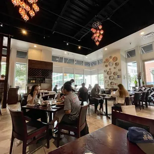 people sitting at tables in a restaurant