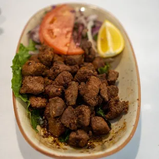 a plate of meat and vegetables