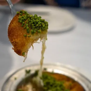 a piece of food being held by a fork