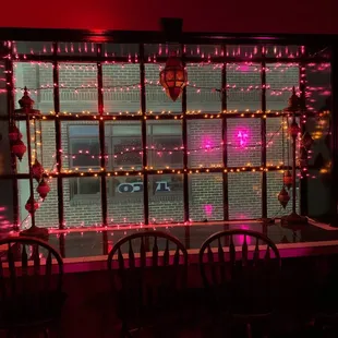 a window decorated with christmas lights