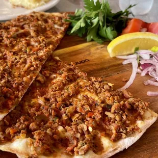 two flatbread pizzas on a cutting board