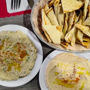 a bowl of hummus and a plate of pita chips