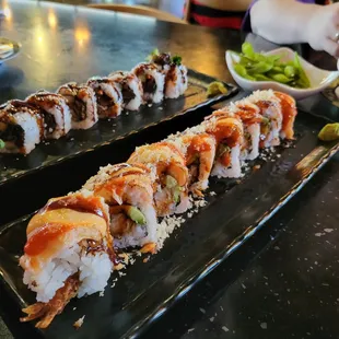 a close up of a sushi roll on a black plate