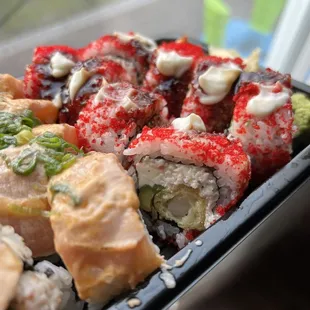 a plate of sushi and rolls