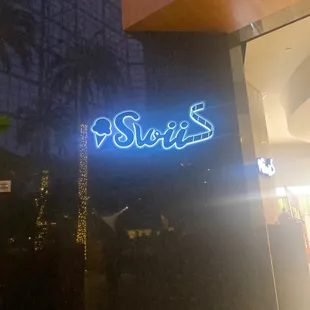 a neon sign that says sweets