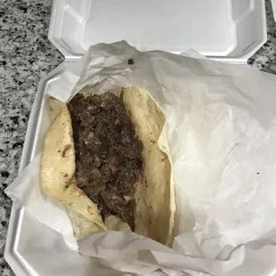 a sandwich in a styrofoam container