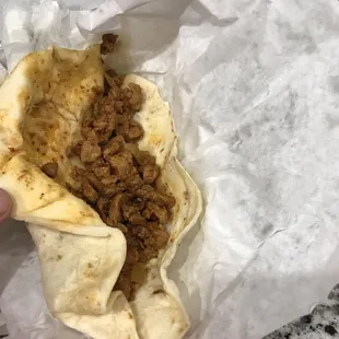 a person holding a burrito