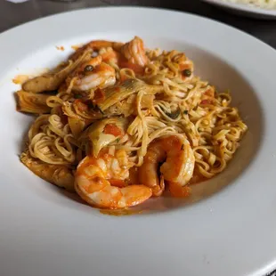 a plate of shrimp and noodles