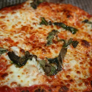 a pizza with cheese and basil