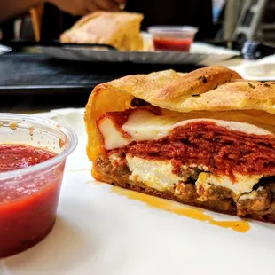 Pepperoni and sausage calzone with red sauce