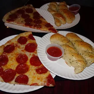 Slices of pepperoni pizza and garlic bread