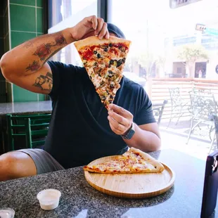 a man eating a slice of pizza