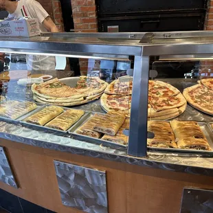 Available pizzas, calzones and strombolis