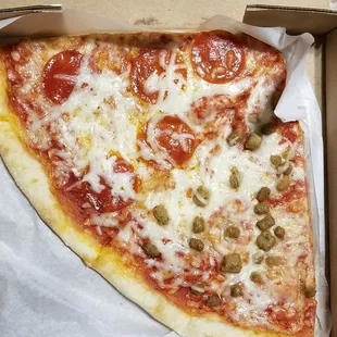 Pizza by the slice.  First Slice pepperoni and the second slice is  Italian sausage