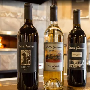 three bottles of wine on a counter