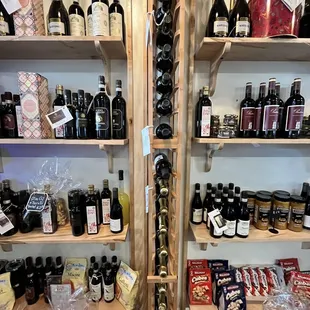 bottles of wine and cheese on shelves