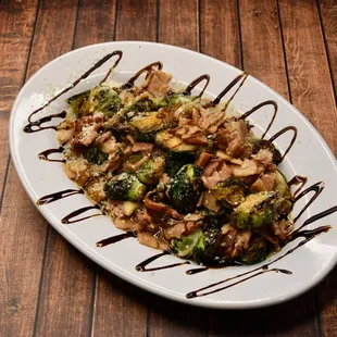 BRUSSEL SPROUTS, 
Sautéed Brussel sprouts with pancetta pork and garlic in a balsamic sauce with parmesan cheese on top