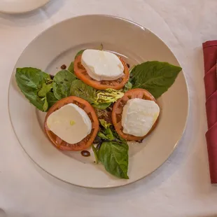 a plate of food with tomatoes and mozzarella