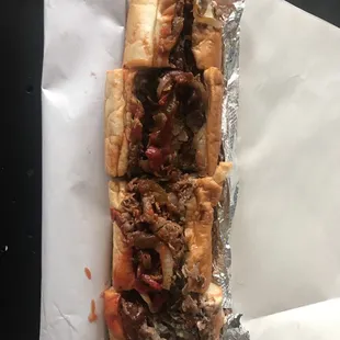 Philly cheese steak with fried onions, hot &amp; sweet peppers and ketchup.