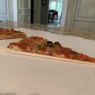 two slices of pizza on a table