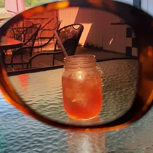 the reflection of a drink in a sunglasses