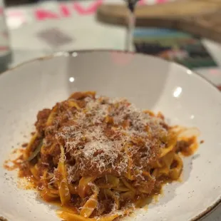 a plate of pasta and a glass of wine