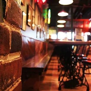 The brick wall and wood floors create a rustic tone.