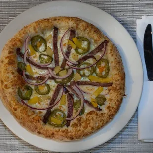 a white plate with a pizza on it