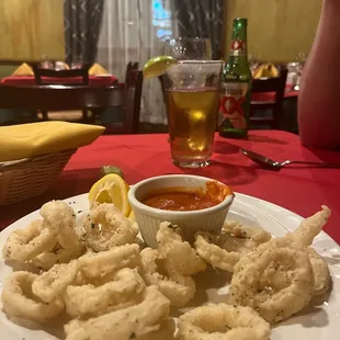 a plate of deep fried squids and dipping sauce
