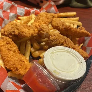 a basket of fried chicken and fries