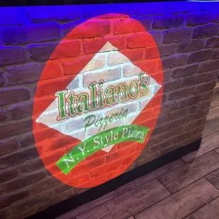 a brick wall with a neon sign