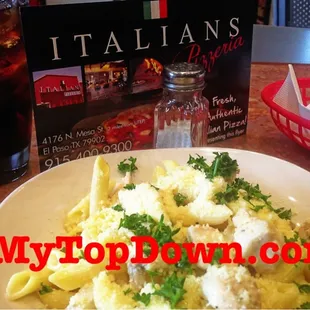 a plate of pasta with cheese and parsley