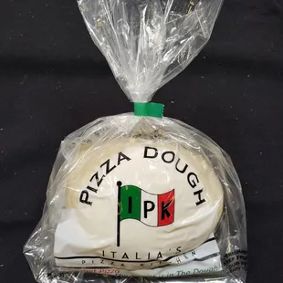 pizza dough wrapped in plastic