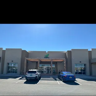 two cars parked in front of a building