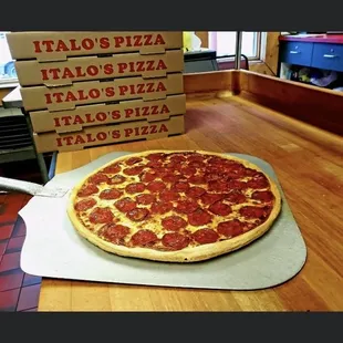 a pepperoni pizza on a table