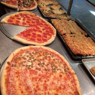 a variety of pizzas on display