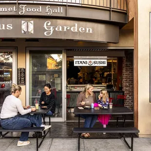 Exterior of Itani Sushi, within the Berkeley food hall, Epicurious Garden. Seating out front along Shattuck Ave, and in the back garden.