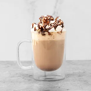 a cup of coffee with whipped cream and chocolate