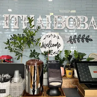 a coffee shop with a sign that says welcome