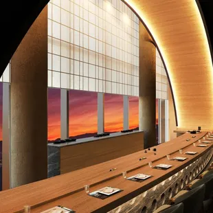 a long dining table with a view of a sunset