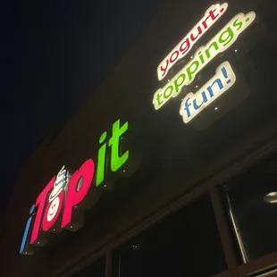 the front of a restaurant lit up at night