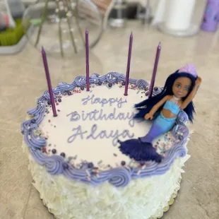 Swiss Black Forest Cake w/white chocolate shavings, purple writing and piping. I added my own sprinkles and Barbie.