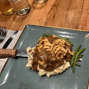 Hamburger steak with mashed potatoes and green beans