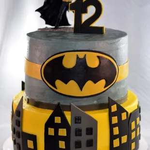Back to save Gotham! Layer 1: Vanilla cake with mango mousse filling, Layer 2: chocolate cake with yellow butter cream (batman colors)