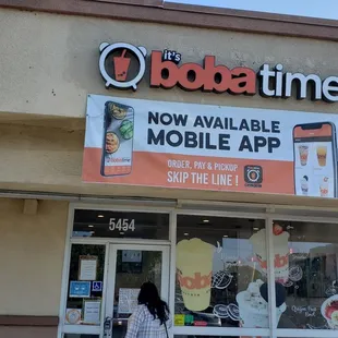a woman walking in front of a store
