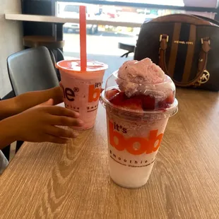 two cups of boba with ice cream and strawberries